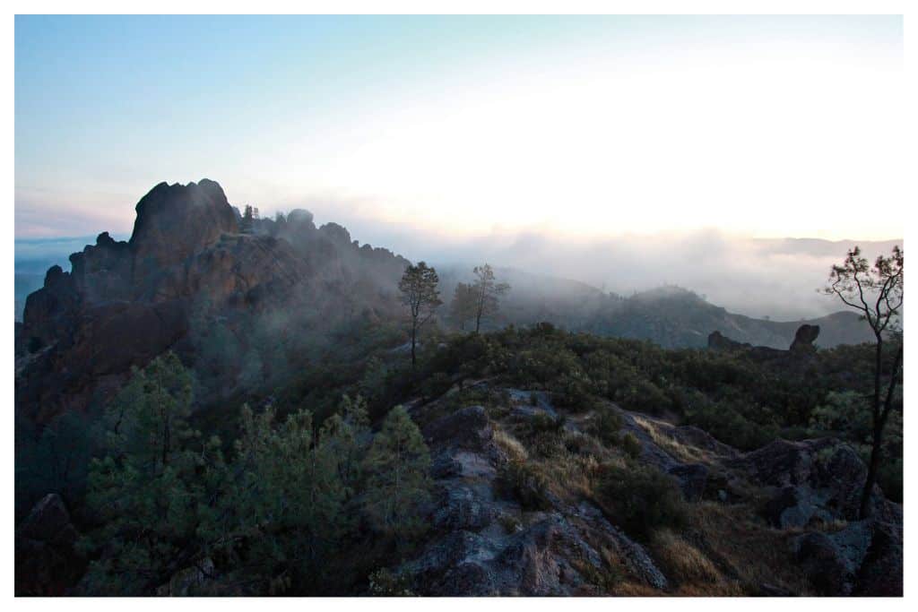 The High Peaks rise above the fog as the sun rises. Hiking the High Peaks Trail is one of the can't-miss things to do at Pinnacles National Park